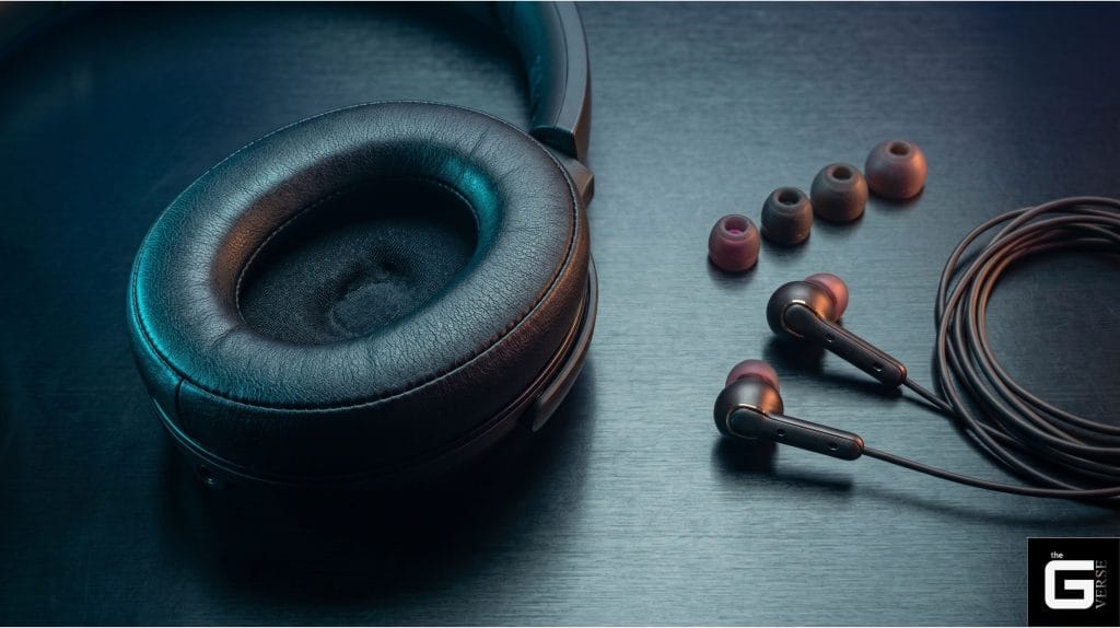Over-ear headphones and IEM earphones on metal surface